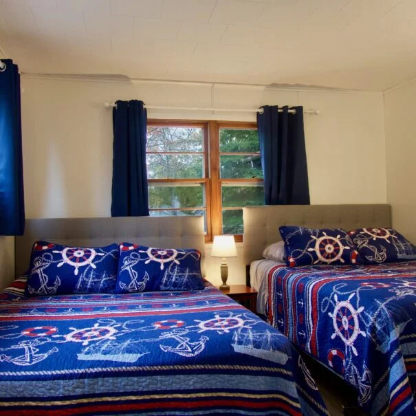 The third bedroom in Cabin 1 at Sunset Shore Mille Lacs shows two queen beds.