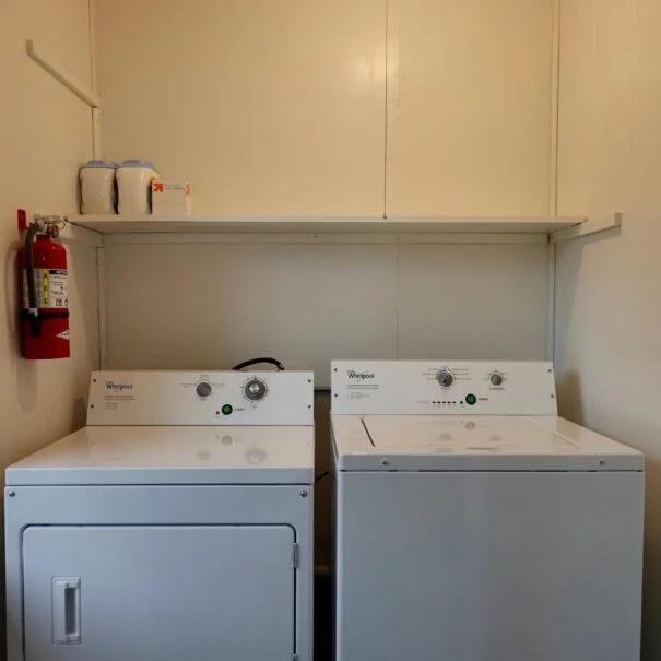 A washer and dryer set inside a cabin.